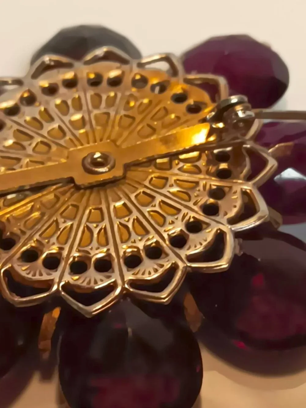 Vintage ruby lucite brooch with aurora borealis central rhinestone.